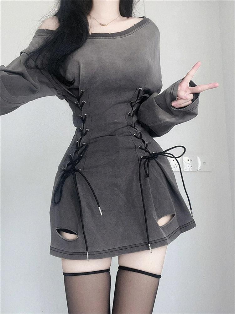 Una chica lleva un minivestido con cordones color humo de Acubi.