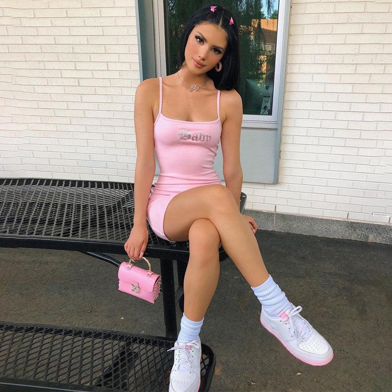 a Barbiecore girl wearing a pink Barbie baby bodycon mini dress