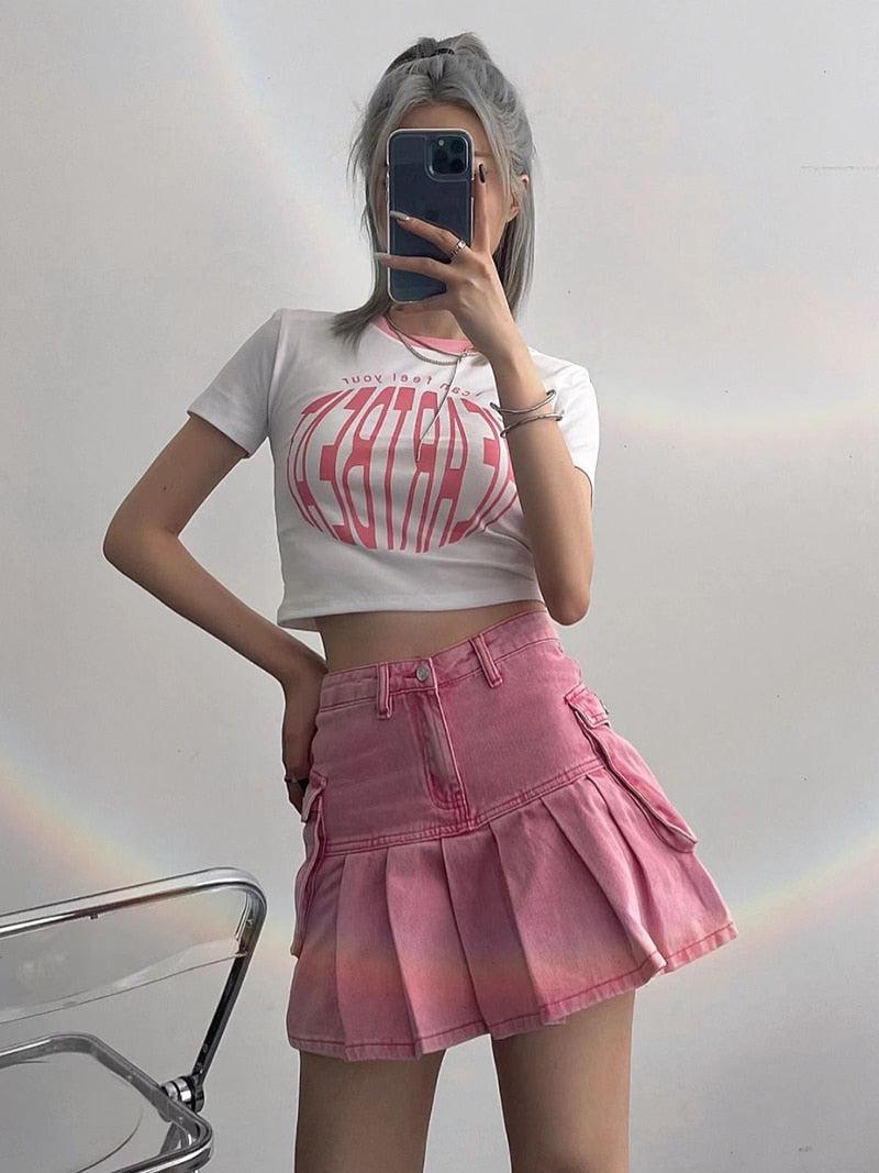 a girl wearing a white Barbiecore top and a Barbie pleated cargo mini skirt