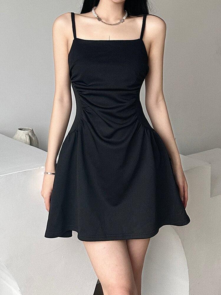 a girl is wearing a black sleeveless mini dress for acubi fashion