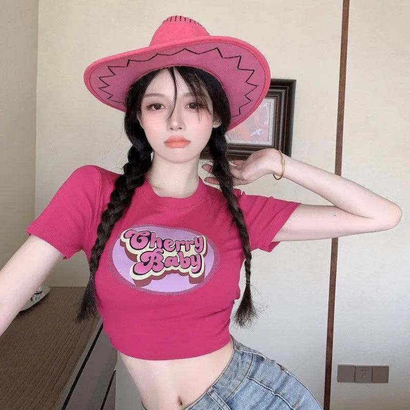 a girl is wearing a cherry baby tee in pink and a pink cowbıy hat for acubi fashion