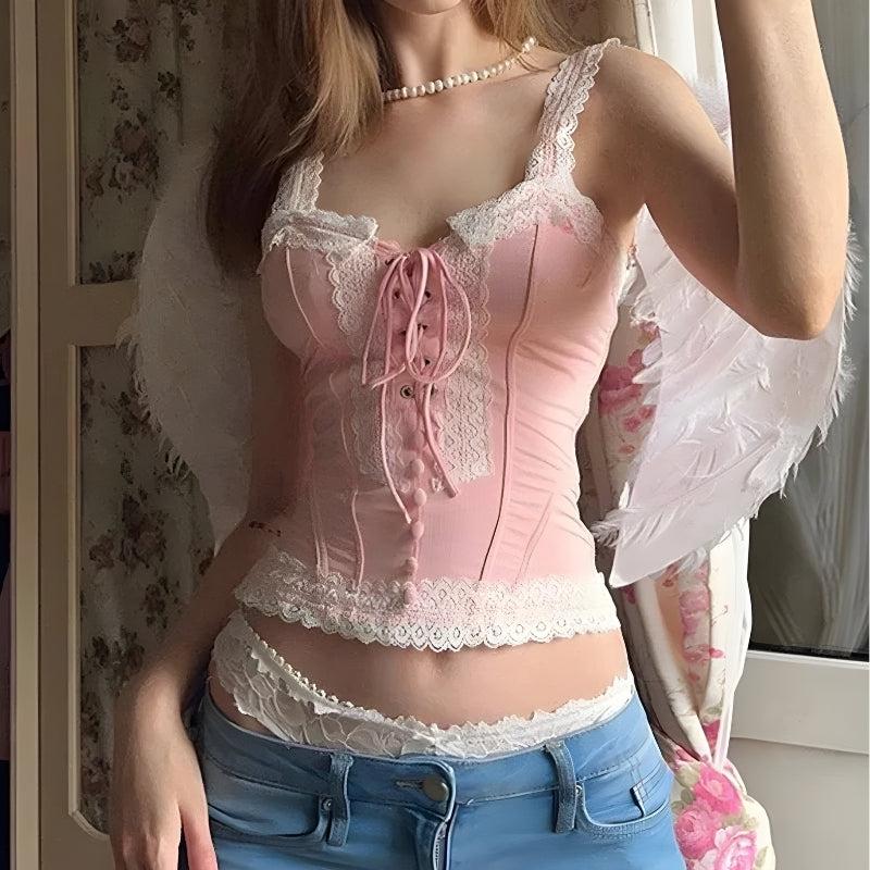 a girl wearing a pink and white coquette aesthetic lace up corset top and jeans and a pearl necklace
