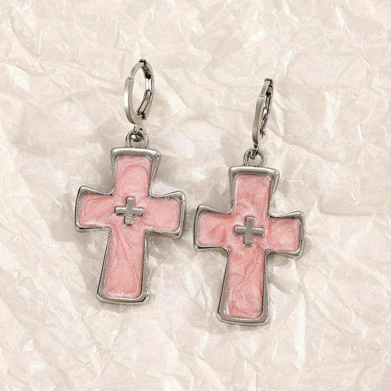 Pastel pink cross earrings with silver hoop closures and a pearlescent inlay, perfect for a subtle shimmer.
