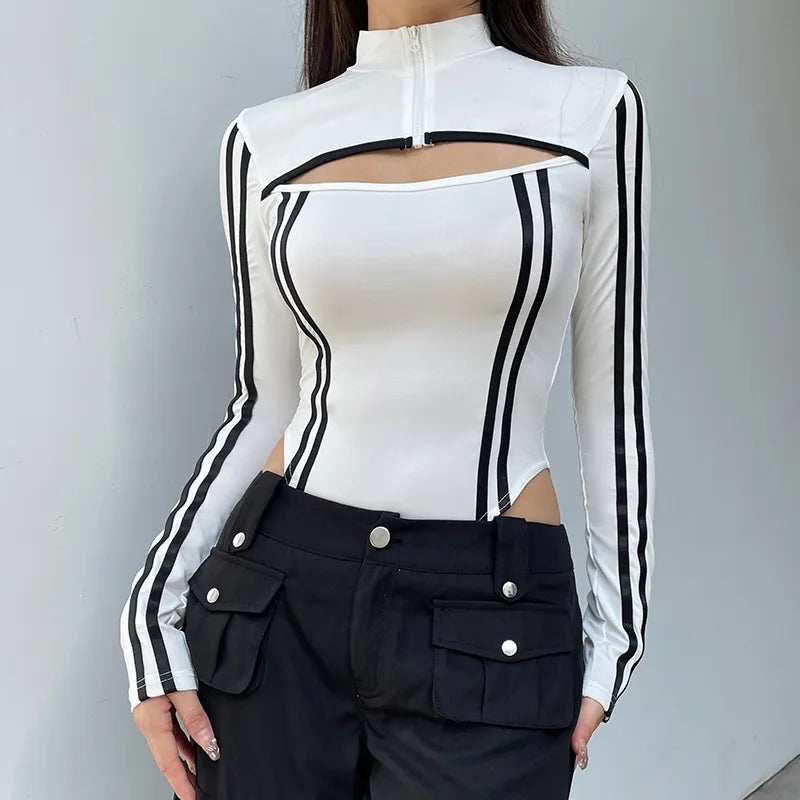 a men is wearing a cyberpunk striped cut out bodysuit in white and the striped are black, she is also wearing black pants