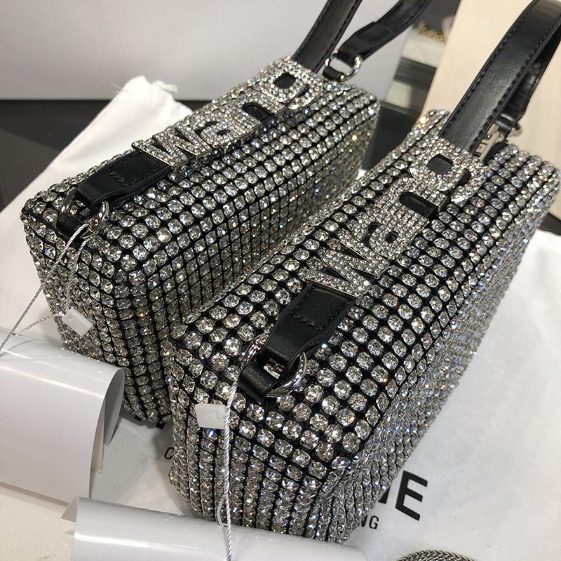 silver disco cowgirl rhinestone handbag with wang written on its stripe also its reflection can be seen in the mirror