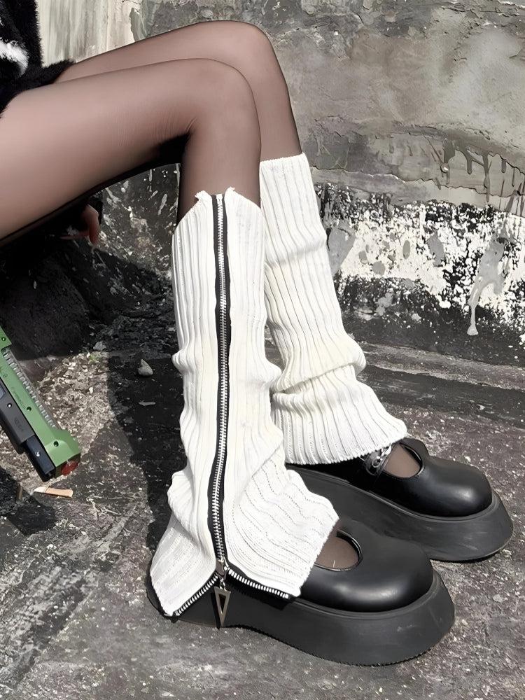 a girl is wearing grunge zip-up knitted leg warmers in white for acubi fashion