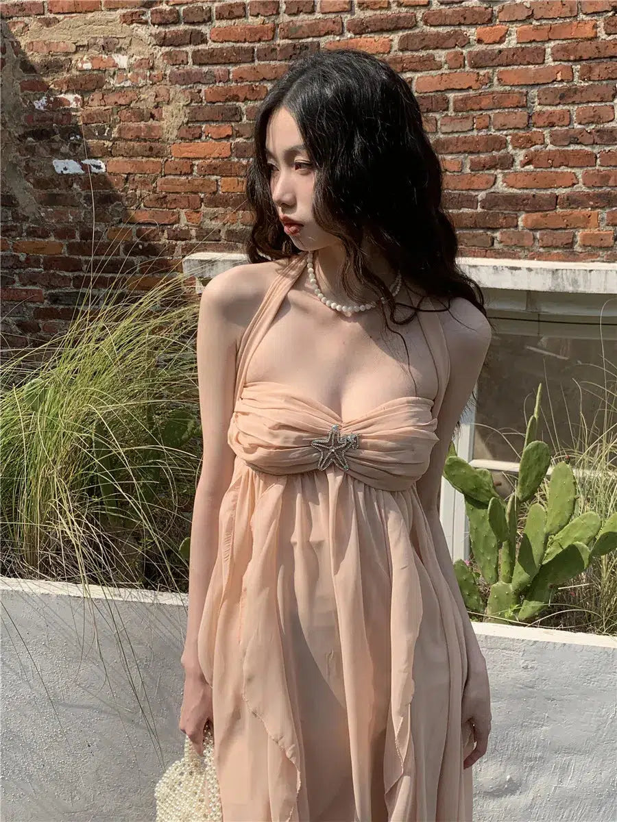 a whimsical aesthetic girl is wearing a light orange backless chiffon midi dress and white shoes