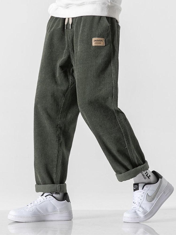 a boy wearing green soft boy corduroy jogger pants