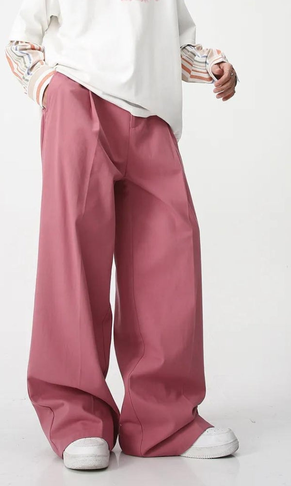 a soft boy wearing green aesthetic high waist baggy pants and a white tee and white shoes