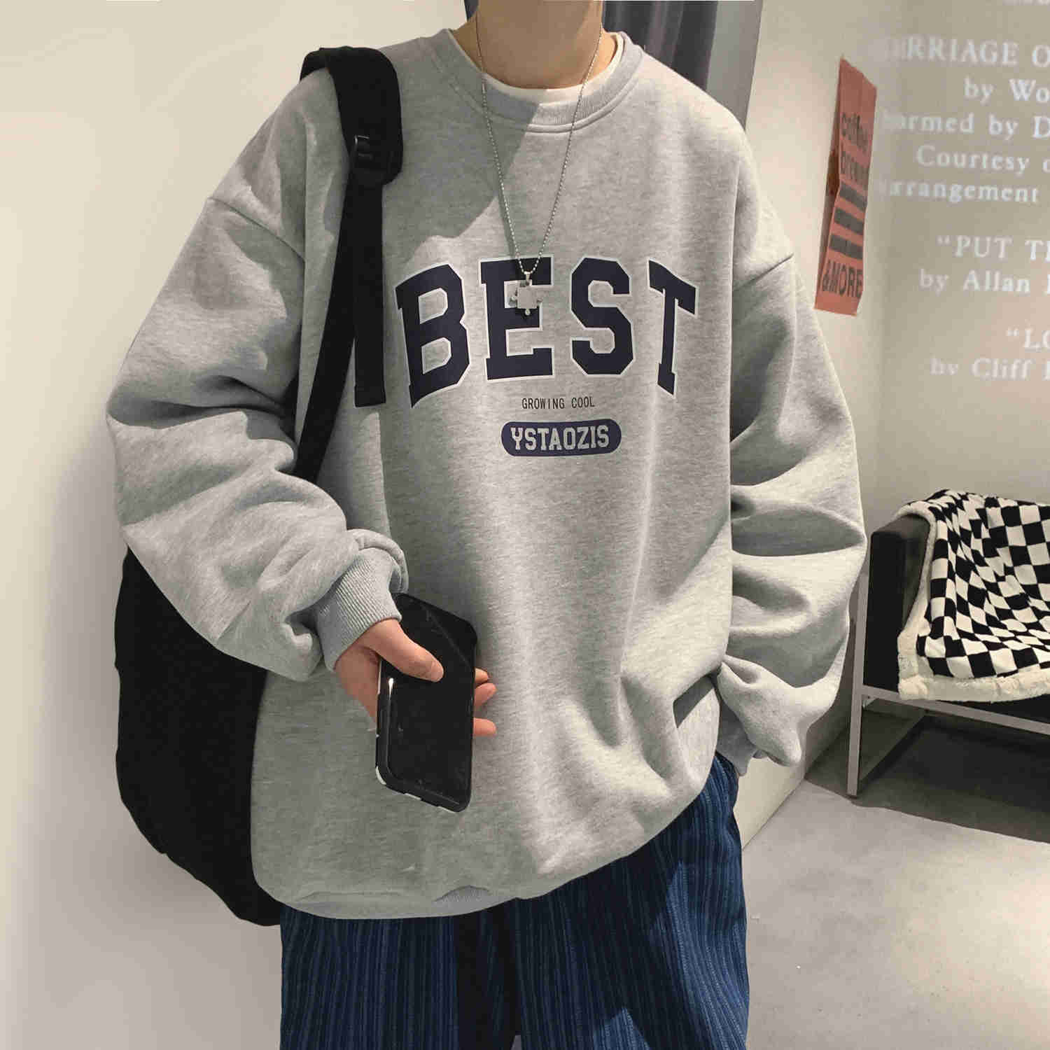 a soft boy wearing a grey aesthetic oversized sweatshirt with a best growing cool ystaozis slogan on