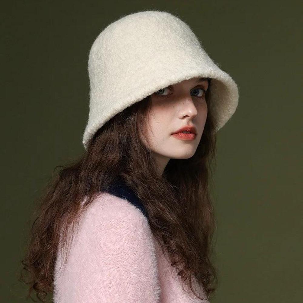 an aesthetic girl is wearing a soft girl white bucket hat and a soft pink top