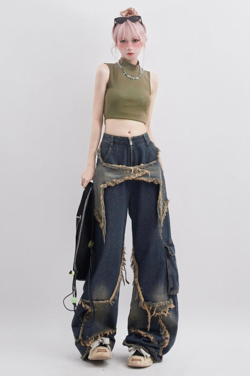 a pink-hair girl is wearing a y2k star patchwork baggy jeans and a khaki crop top and a silver necklace