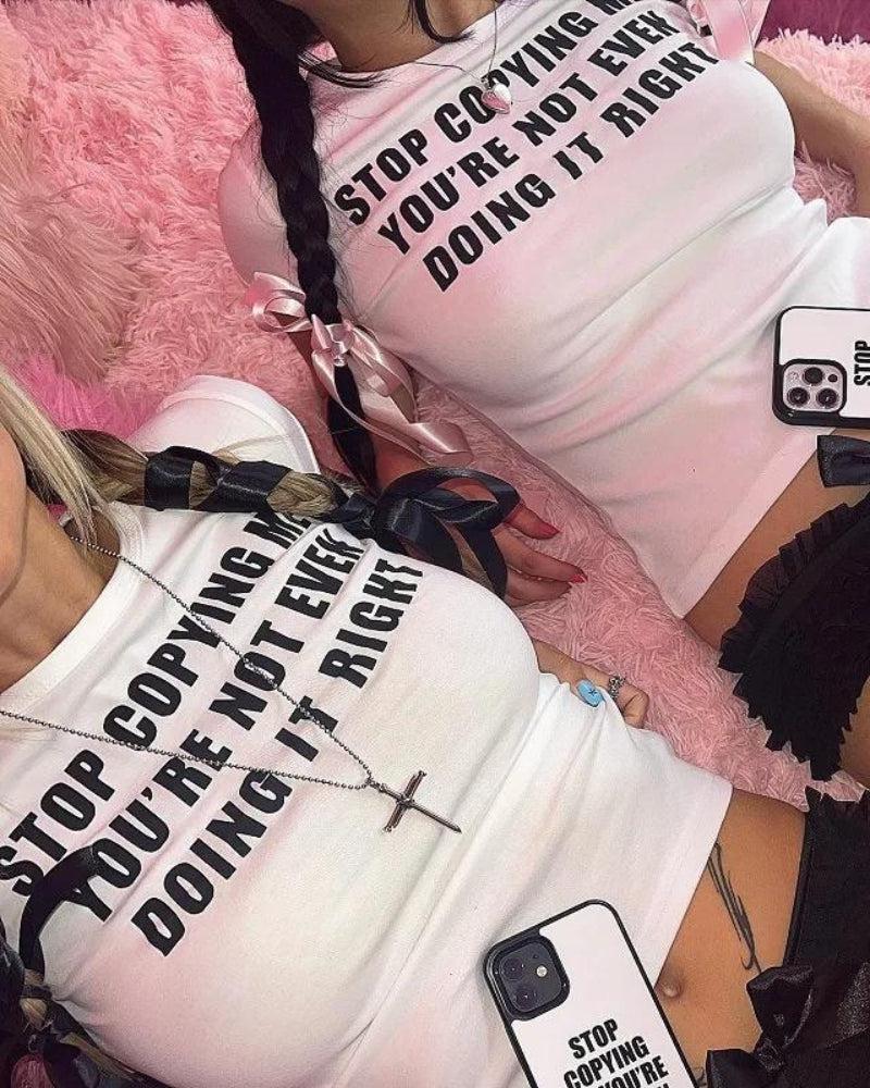 two girls are wearing stop copying me you are not even doing it right baby tees in white