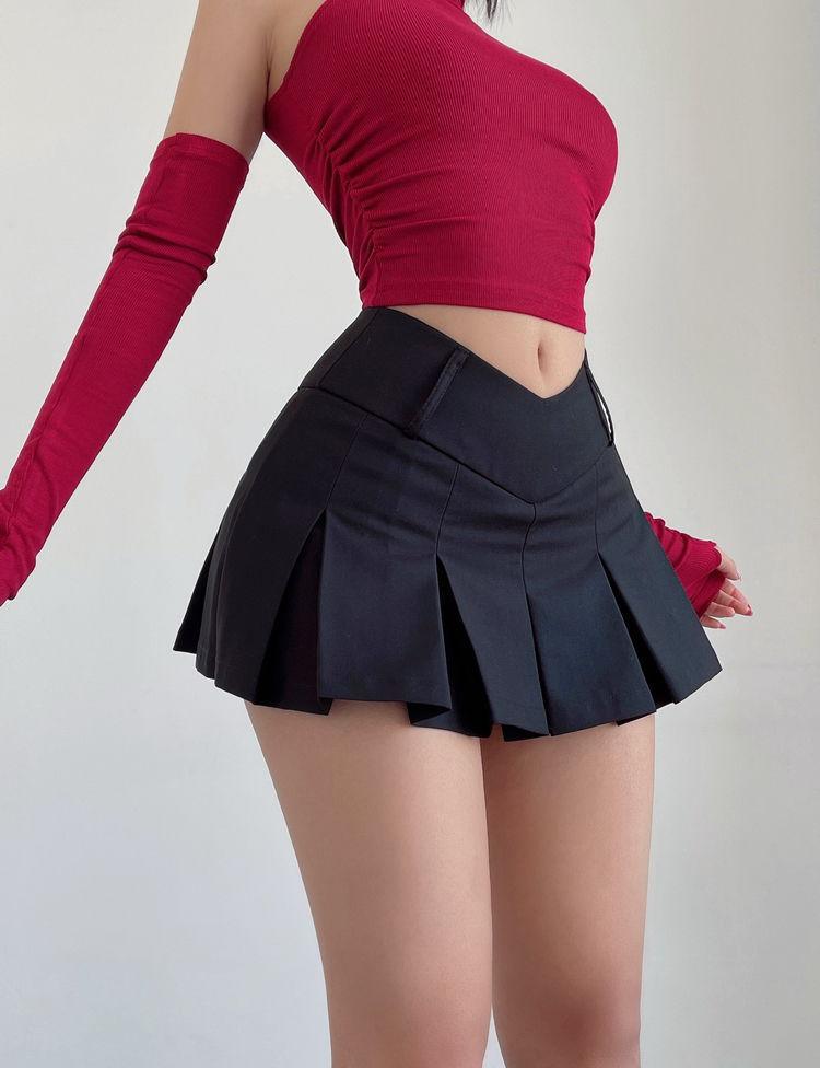 a girl is wearing a black v-shaped college aesthetic mini skirt and a red top with arm details