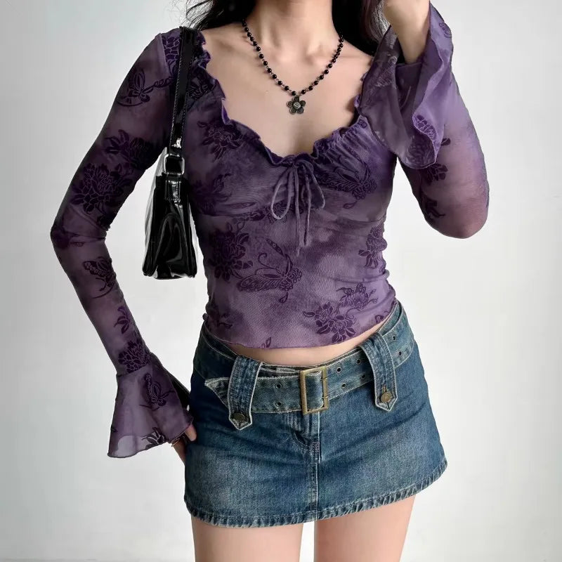 a girl is wearing a purple Y2K floral mesh top with ruffled neckline and tie front detail