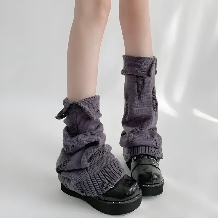 Model wearing Y2K grunge distressed knitted leg warmers in gray, styled with ruffled mini skirt and platform shoes, showcasing cozy elastic knit design for edgy fall and winter outfits.