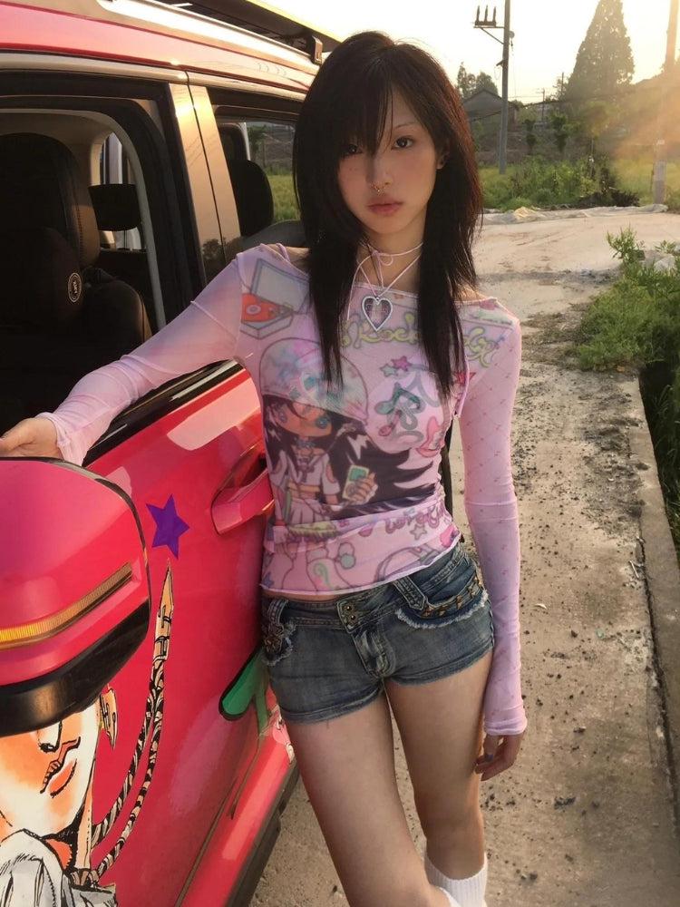 a girl is wearing a pink Y2K mesh top with graphic print and long sleeves